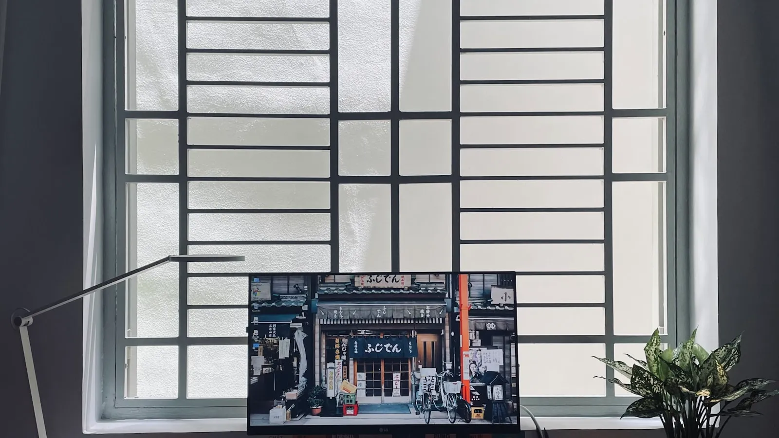 A computer keyboard on a wooden desk