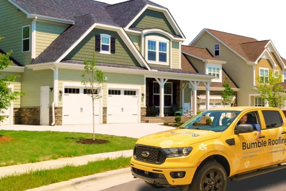 A roofing contractor's service truck parked outside a suburban home